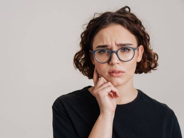 woman contemplating an at-home fertility test vs going into a fertility clinic to get it done