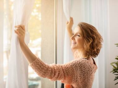 woman looking out open fertility window